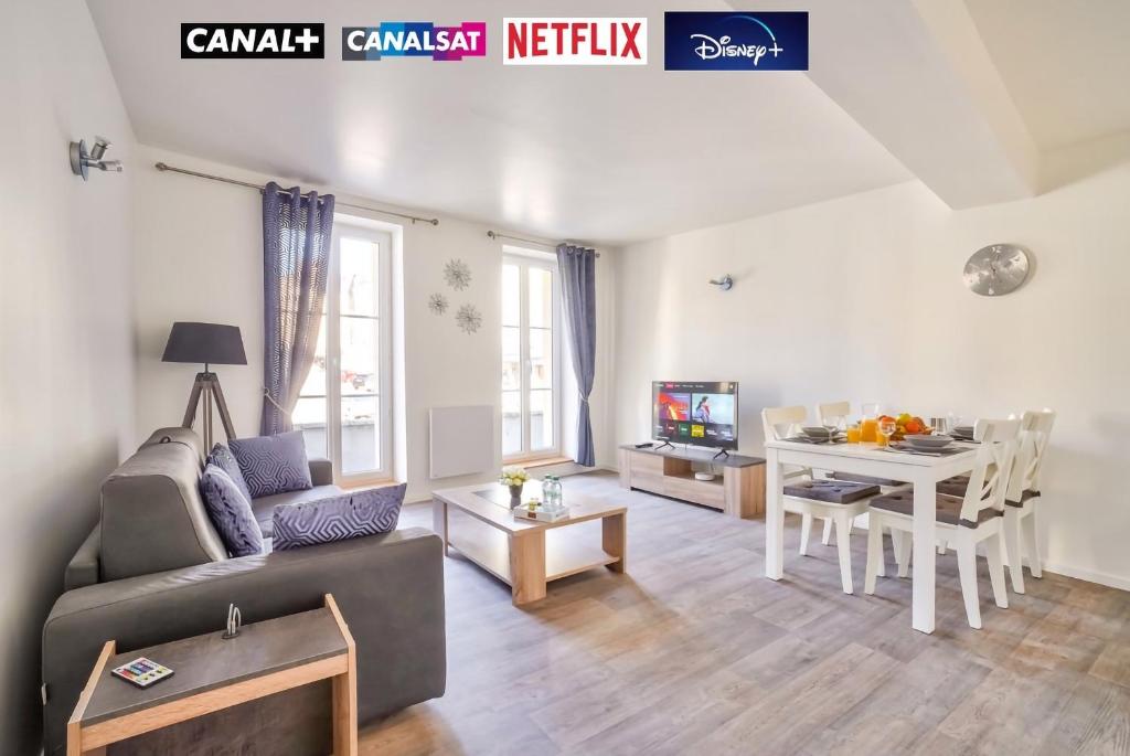 a living room with a couch and a table at Top Destination Pontoise in Pontoise