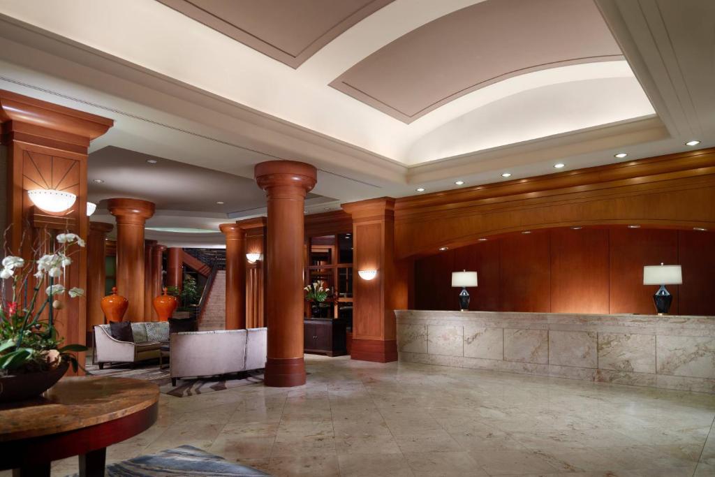 a lobby of a hotel with columns and a reception desk at Marriott Jacksonville Downtown in Jacksonville