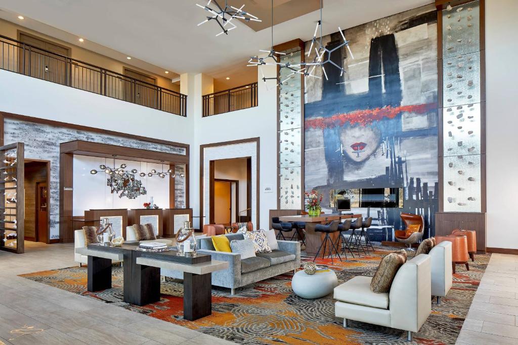 a living room with a large painting on the wall at Renaissance Chicago Glenview Suites Hotel in Glenview