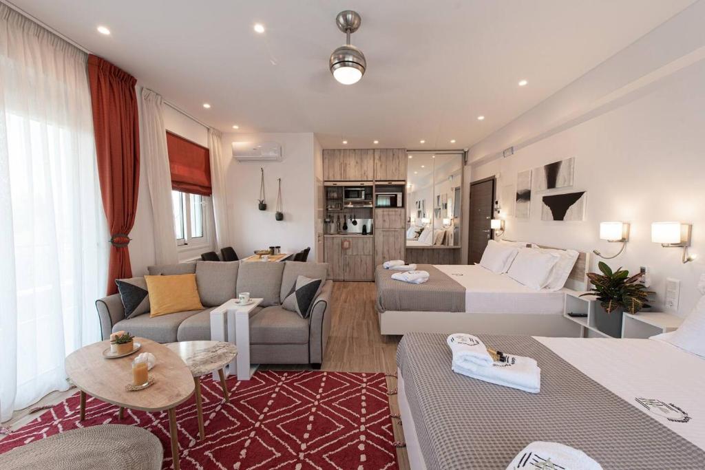 a living room with a couch and a bed and a living room at Bukovo Apartment - Hellenic Apartments Avlona in Oinófita