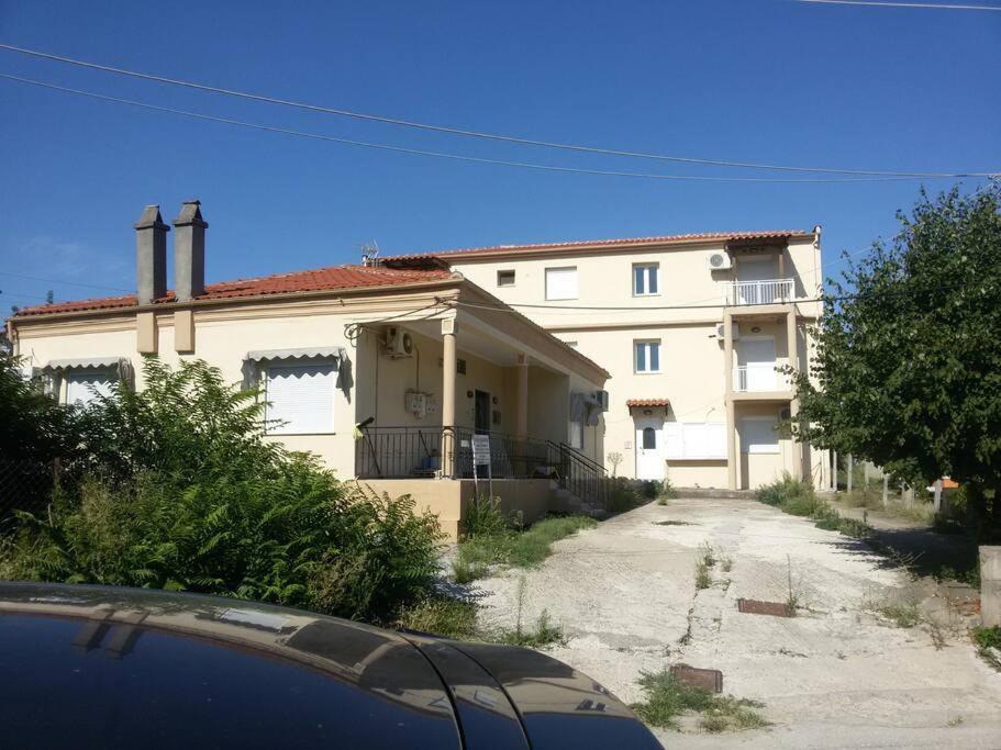 a house with a car parked in front of it at Zap Home - Διαμέρισμα 9 in Souflíon