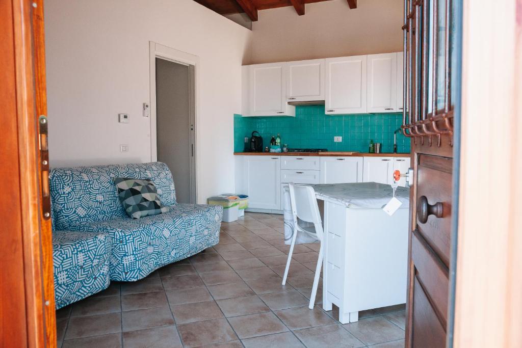 a kitchen with a couch and a table in a room at Magnolia Rooms in Civitavecchia