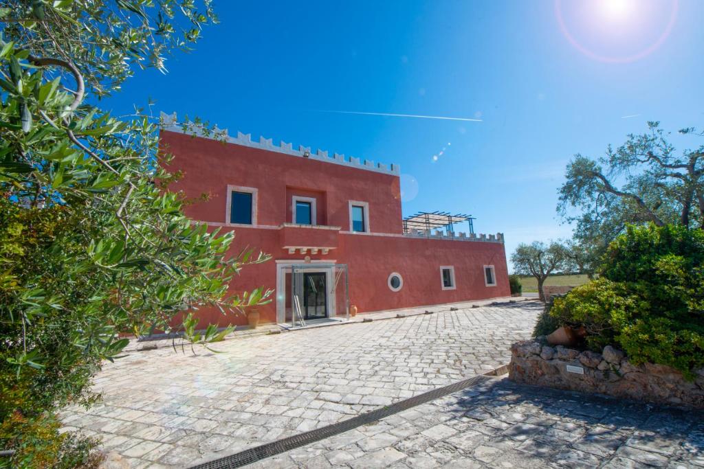 an external view of a red building at Grand Hotel Masseria Santa Lucia in Ostuni