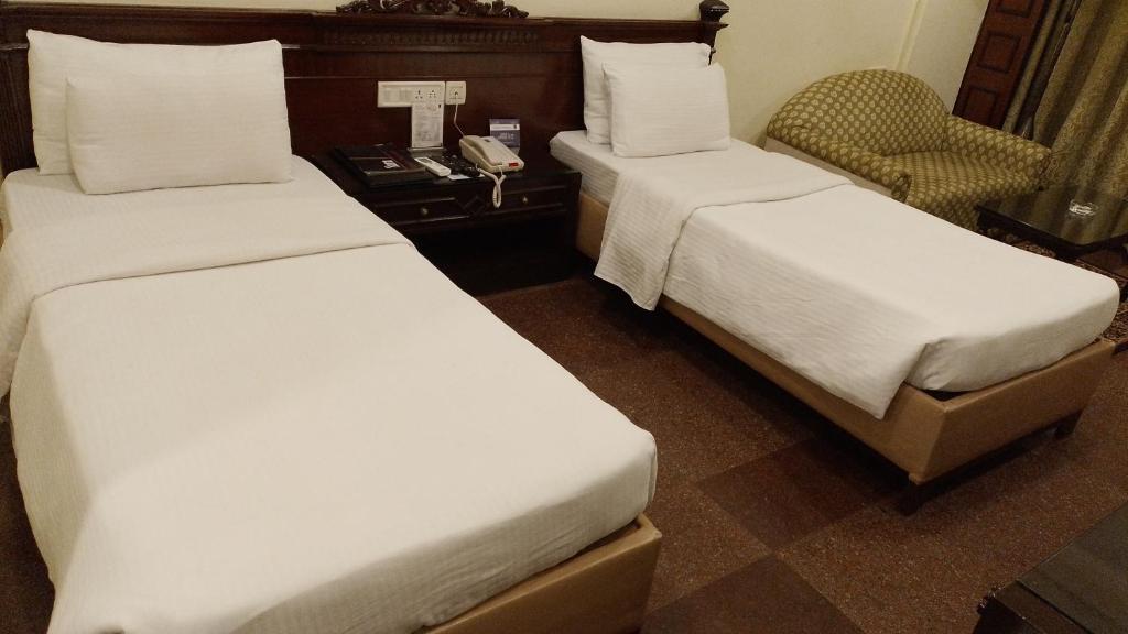 Postel nebo postele na pokoji v ubytování Hotel Empires
