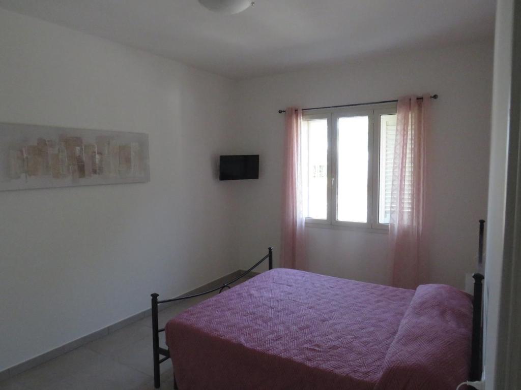 a bedroom with a bed and a window at Il Tarassaco-exclusive pool in Santa Maria a Monte