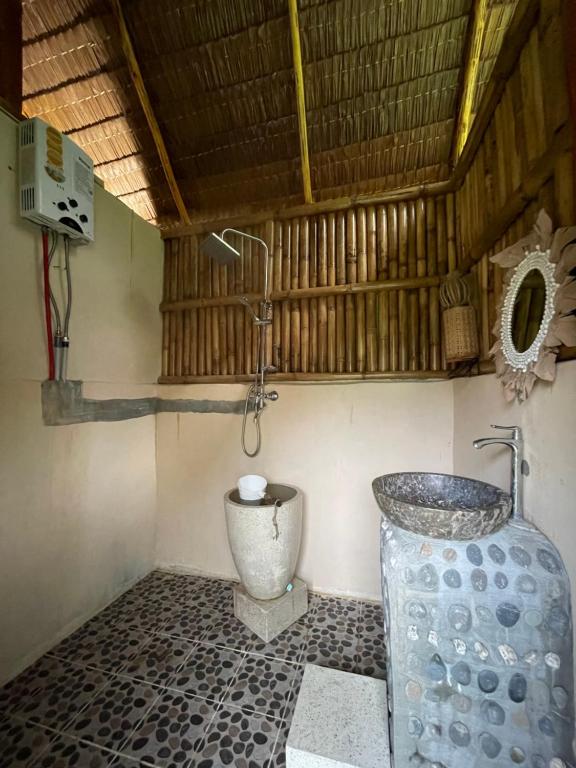 a bathroom with a toilet and a sink at Tangkahan Eco Glamping 