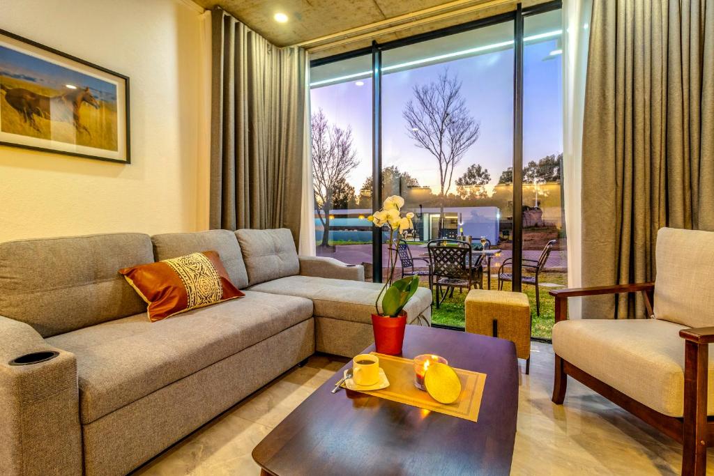 a living room with a couch and a table at KRAVIT Premier Suites in Midrand