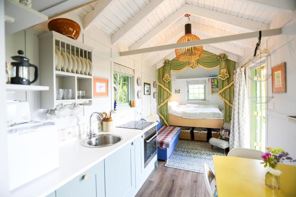 a kitchen and living room in a tiny house at Cottage Orné in Long Bredy