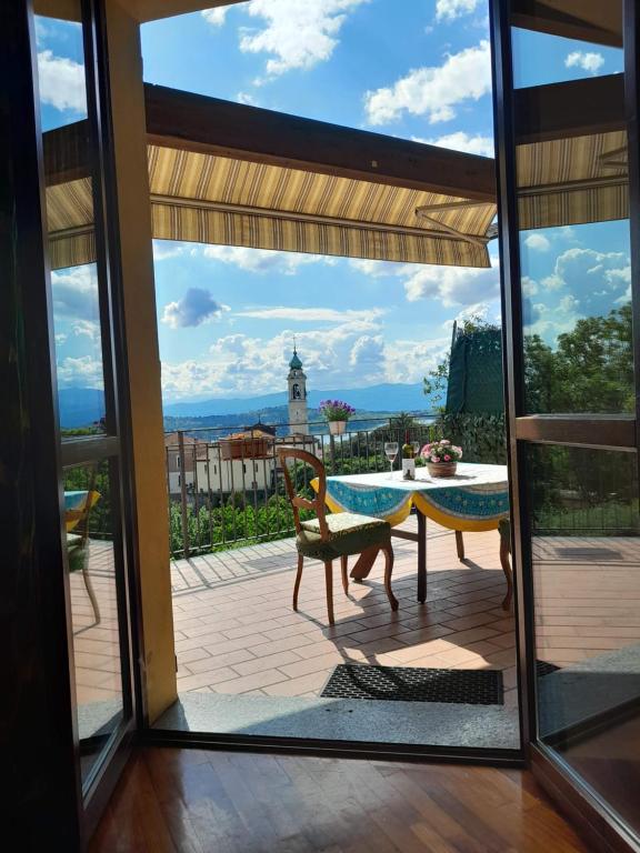 a view from the patio of a house with a table and chairs at Tramonto al Lago in Gavirate