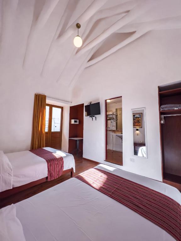 Postel nebo postele na pokoji v ubytování Hotel Cusco Plaza Saphi
