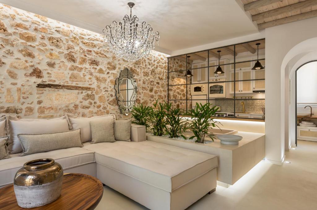 a living room with a couch and a chandelier at il Campanile Luxury Living in Chania