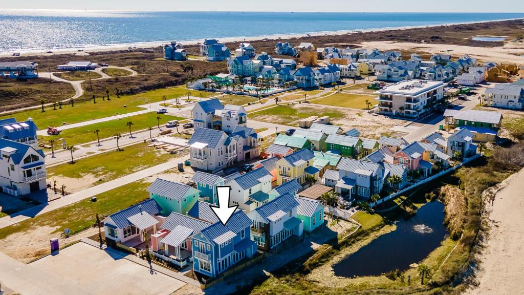 an aerial view of a beach with houses at Coastal luxury steps from the shore and resort amenities in Port Aransas