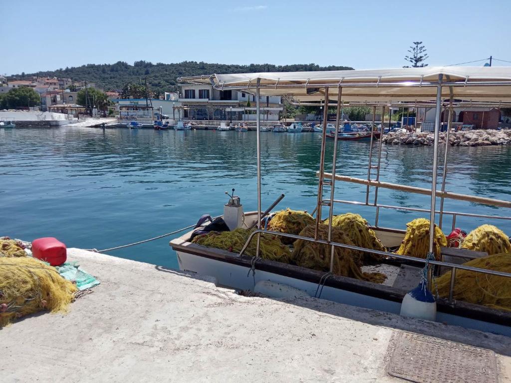 a boat tied up to a dock in the water at Dora's house in Katarráktis