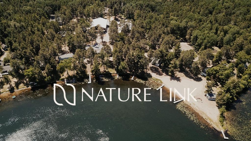 an aerial view of a lake with the words nature link at Nature Link Resorts in Nisswa