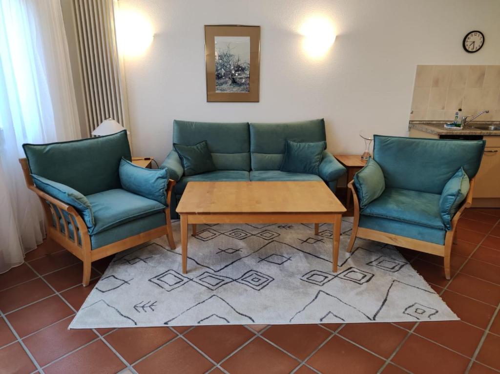 a living room with two chairs and a couch and a table at Apartment Naturgenuss in Dewichow