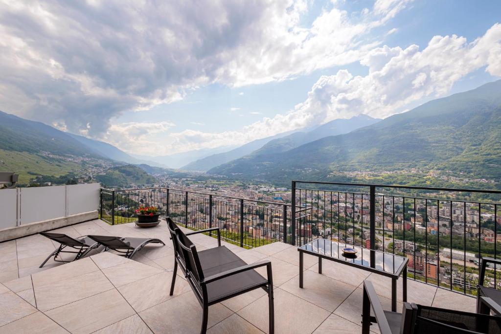a balcony with a view of a city and mountains at REVO Apartaments - Gualzi63 the Best View in Sondrio
