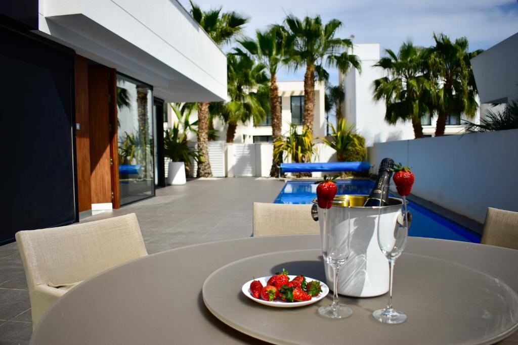 einen Tisch mit einem Teller Essen und einem Getränk in der Unterkunft Luxury Villa LAGUNA - Ciudad Quesada in Ciudad Quesada