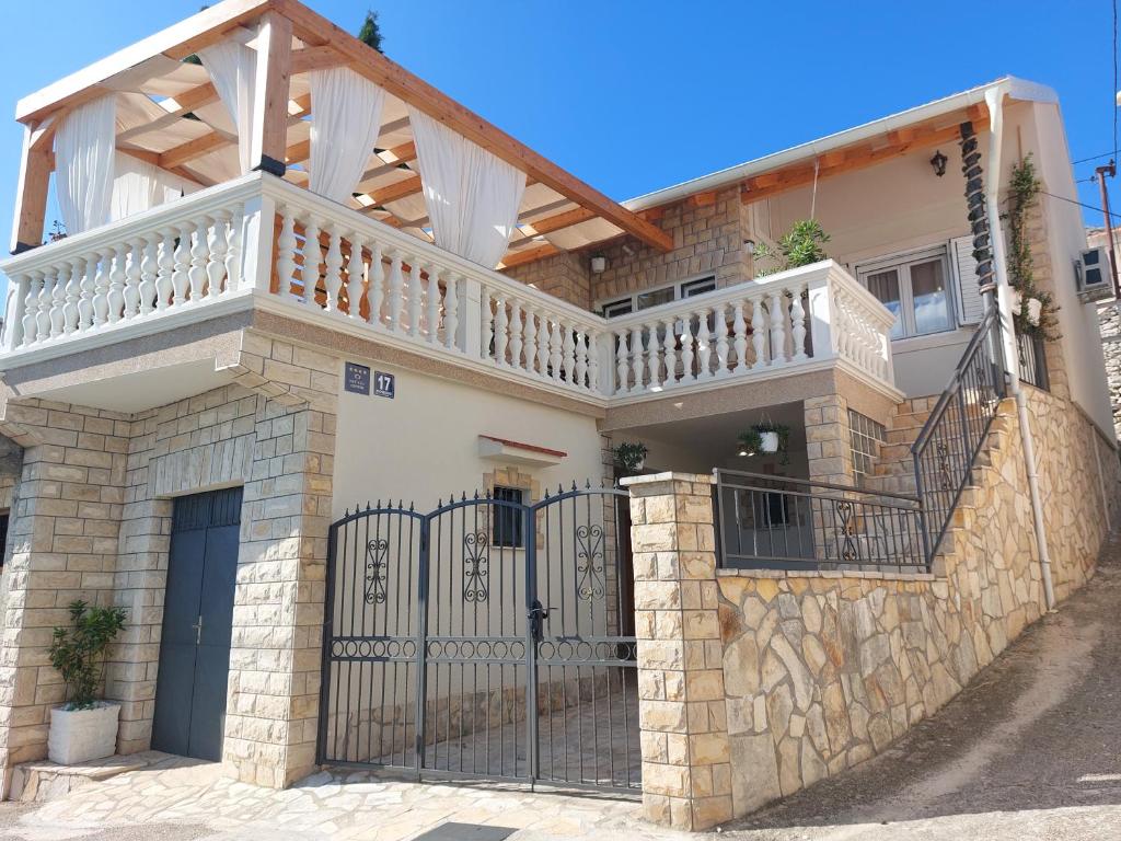 a house with a balcony on top of it at Holiday Home Peran in Grebaštica