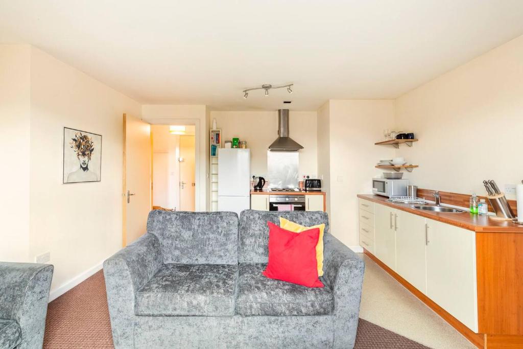 sala de estar con sofá y almohada roja en Mosh Aparthotel Salford en Mánchester