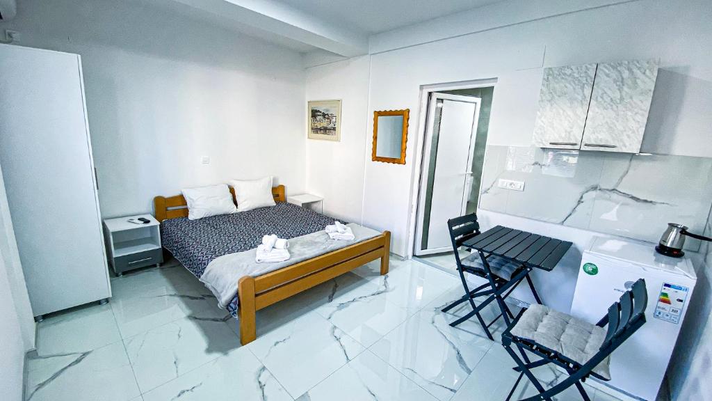 a bedroom with a bed and a table and chairs at Vila Shogun in Ohrid