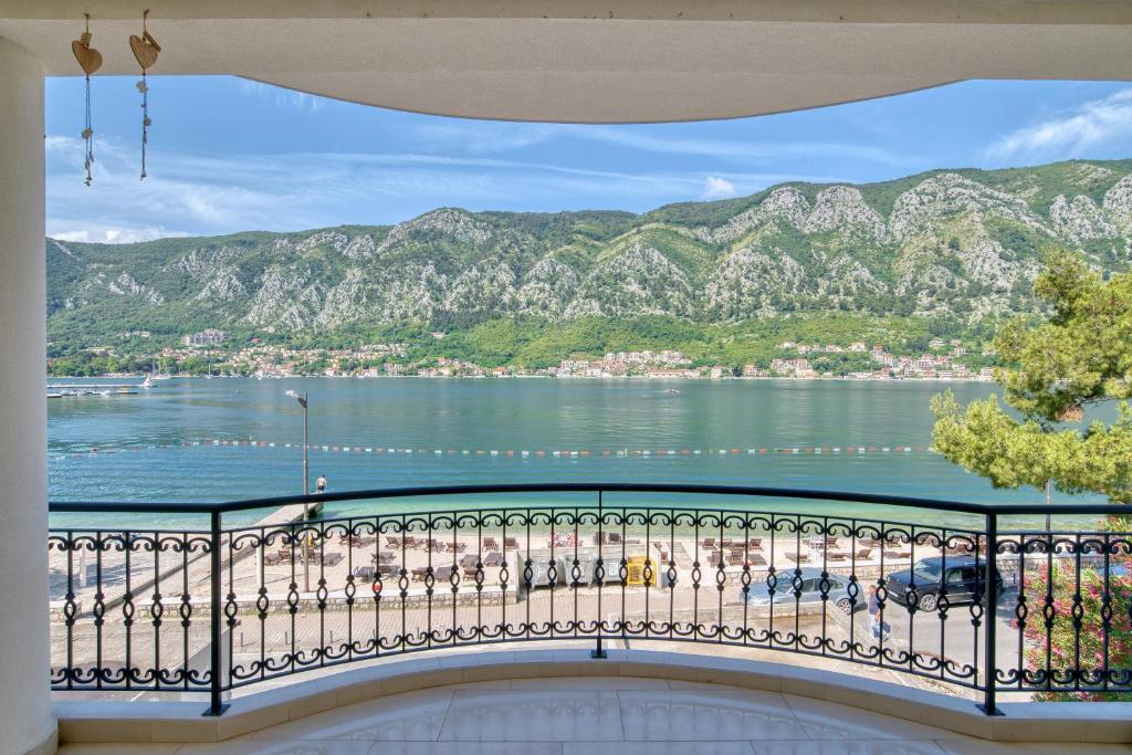 a balcony with a view of the water and mountains at The Golden Luxury complex - Central and Seaboard in Kotor