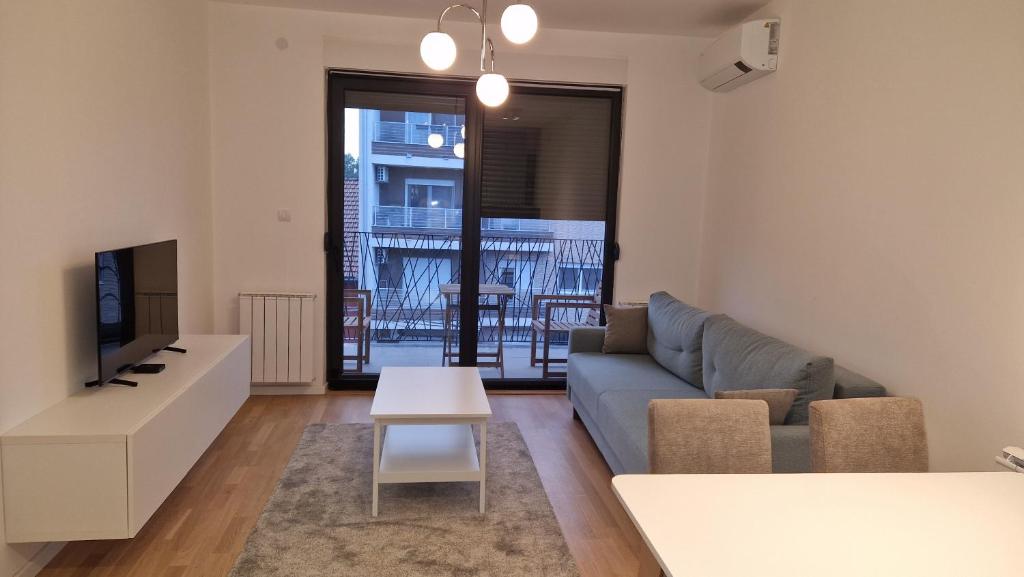 a living room with a couch and a table at Apartment DT48 in Pančevo