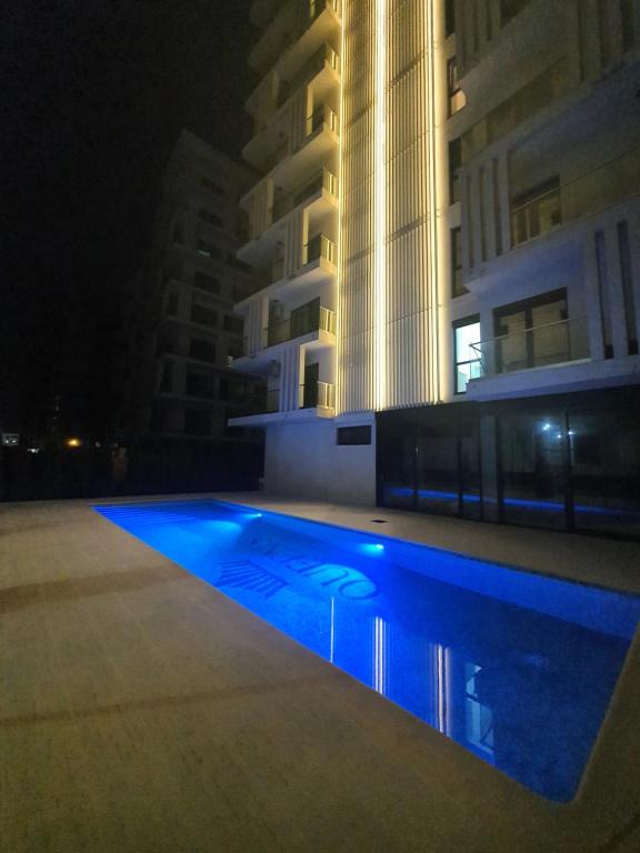a swimming pool in front of a building at night at Studio Alex in Năvodari