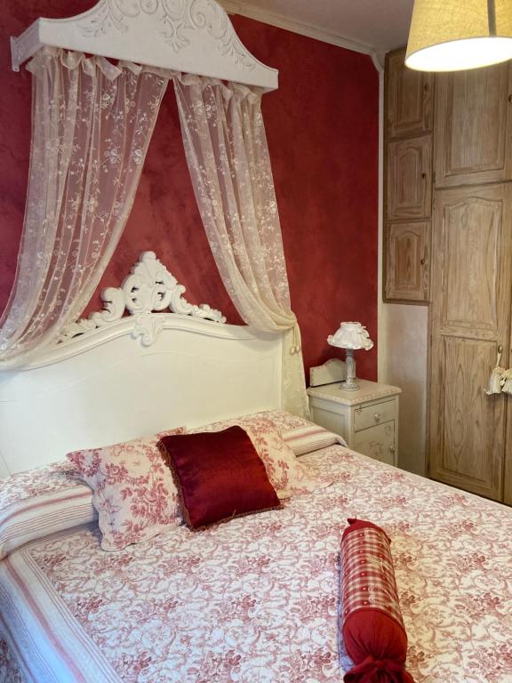 a bedroom with a large bed with a canopy at La Caponera in Riccò del Golfo di Spezia