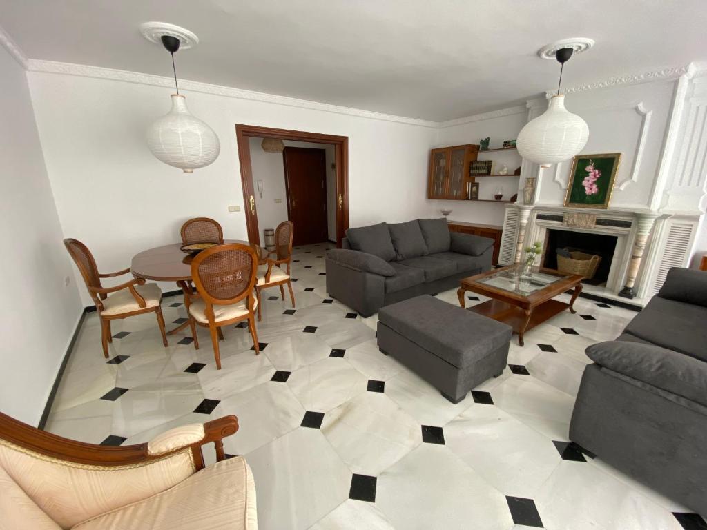 sala de estar con sofá y mesa en En playa, céntrico y acogedor en Fuengirola