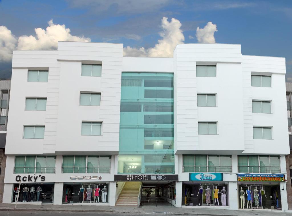 a white building with a store in front of it at Hotel Andino in Bucaramanga