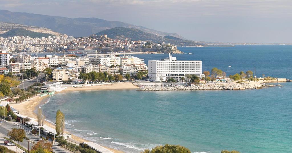 a view of a beach with buildings and the ocean at Madeline house in Kavala