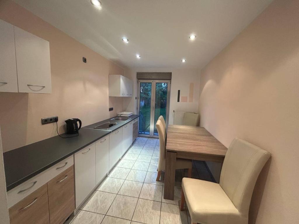 a kitchen with a table and chairs and a counter at 2 Zimmer Wohnung 1min Messe Köln in Cologne