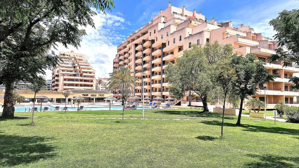 a park with trees and a large building at Paradise Luxury Apartment - Praia da Rocha in Portimão