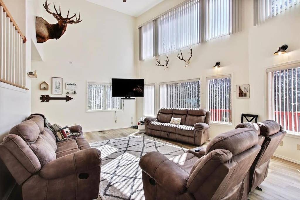 a living room with two couches and a flat screen tv at Cascade Cabin Mountain Getaway with Private Beach in Cascade