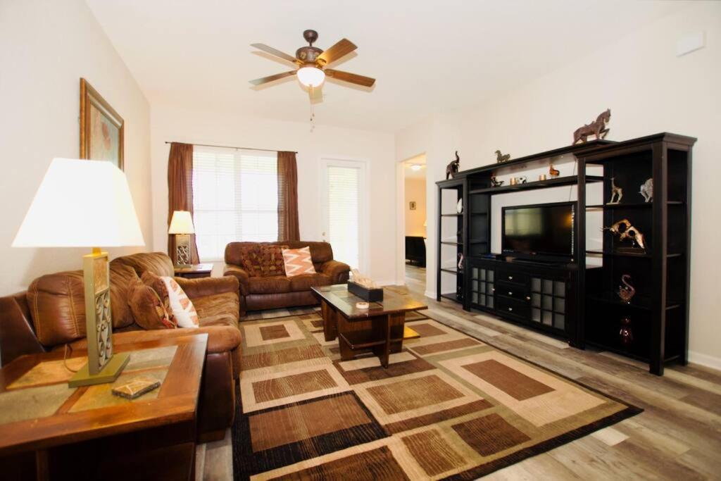 a living room with a couch and a television at Vista Cay Luxury Loft in Orlando