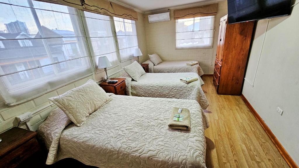 Postel nebo postele na pokoji v ubytování Hostal Aires del Sur Centro de Rancagua