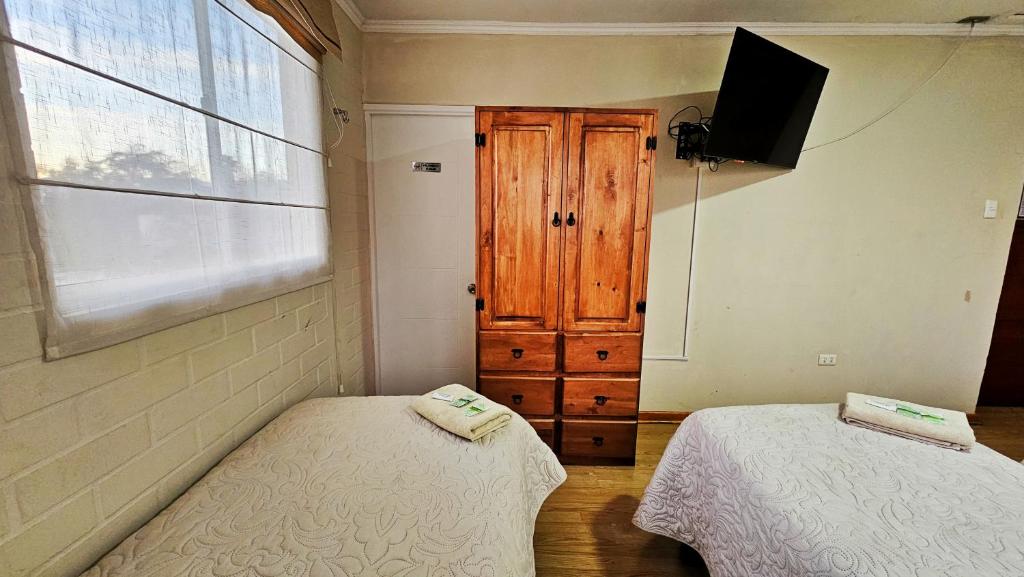 Postel nebo postele na pokoji v ubytování Hostal Aires del Sur Centro de Rancagua