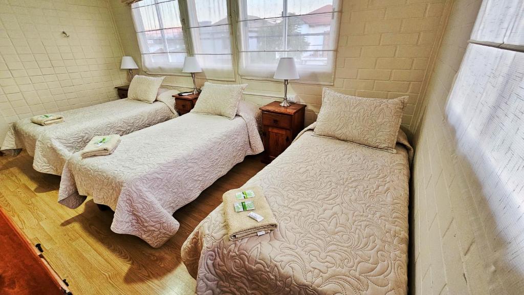 Postel nebo postele na pokoji v ubytování Hostal Aires del Sur Centro de Rancagua