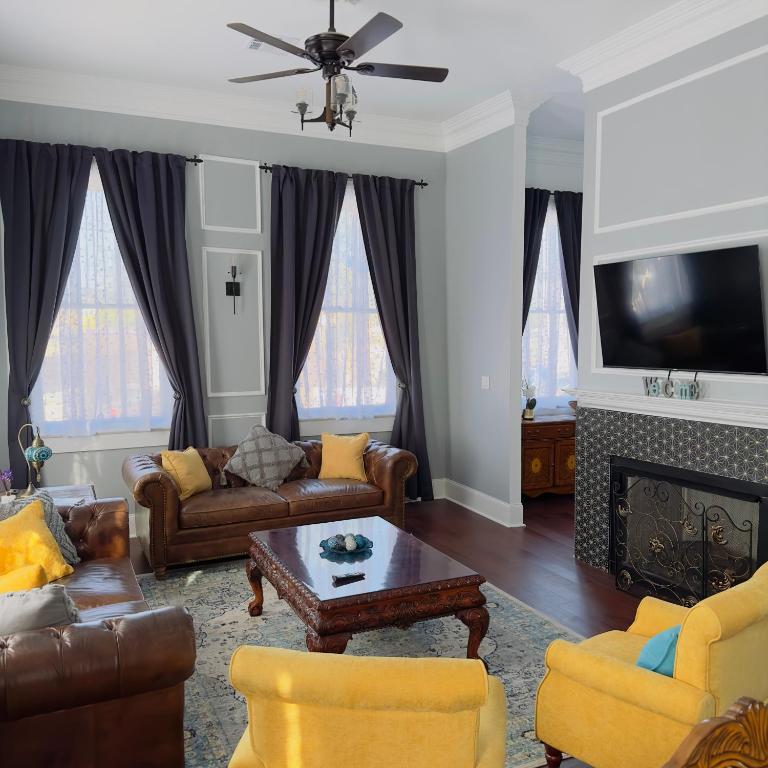 a living room with couches and a tv at Walk to French Quarter Canal Suite Guesthouse in New Orleans