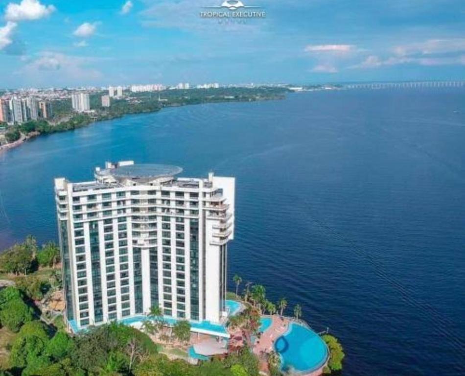 uma vista aérea de um grande edifício junto à água em Flat Hotel Tropical Executive Praia Ponta Negra em Manaus