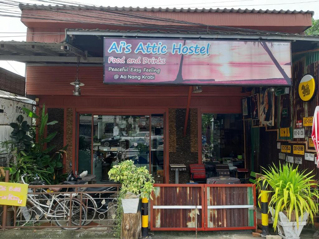 una tienda con un cartel en la parte delantera en Ai's Attic Hostel en Ao Nang