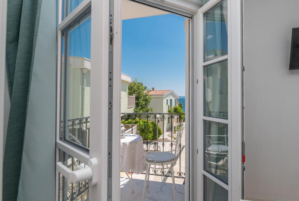 a sliding glass door with a view of a balcony at ORKA 5 in Promajna