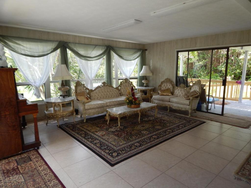 a large living room with couches and a table at Fern Forest Getaway in Volcano