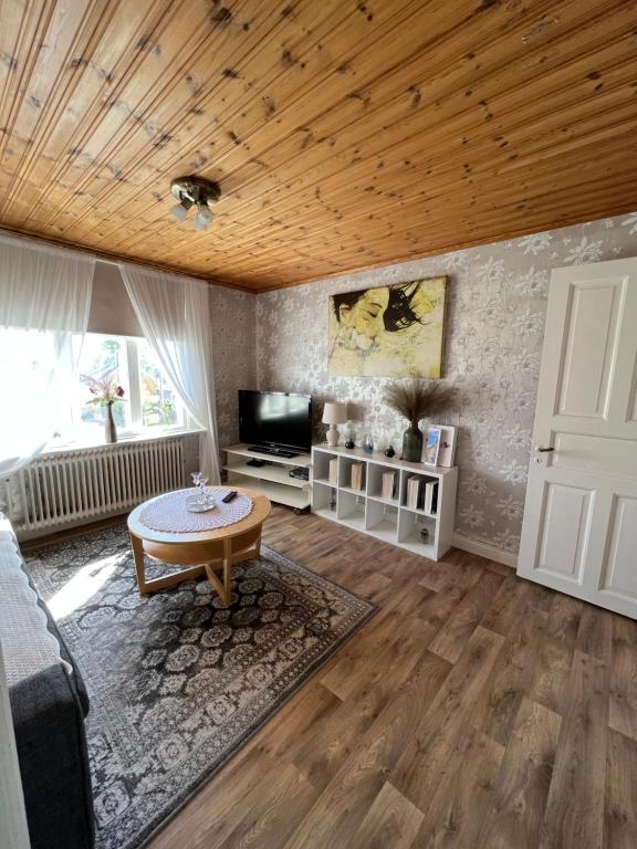 a living room with a couch and a table at Arvika, Centralt in Arvika