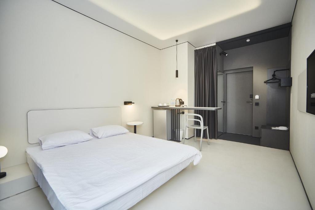 Postel nebo postele na pokoji v ubytování Ultramarinn Hotel