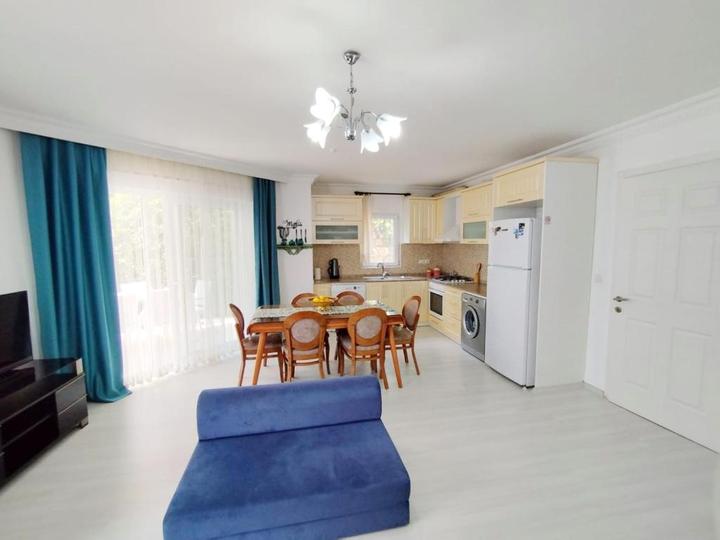a kitchen and dining room with a table and chairs at Manolyam suit havuzlu 2+1 in Kaş
