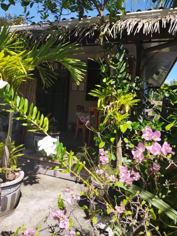 a garden with plants and flowers in front of a house at Tiki House in Bora Bora