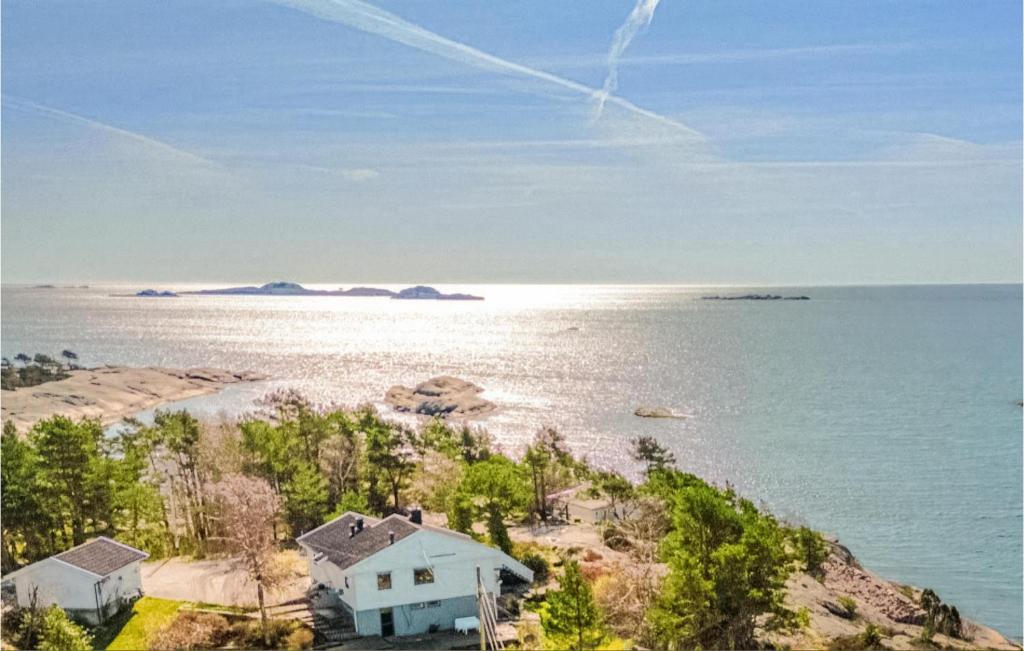 an aerial view of a house on the shore of a body of water at 4 Bedroom Pet Friendly Home In Sgne in Søgne