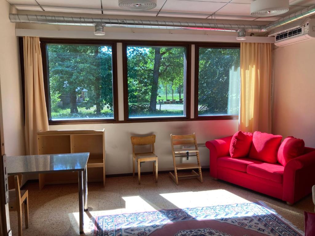 a living room with a red couch and a table at Sippolantie 11 in Kouvola