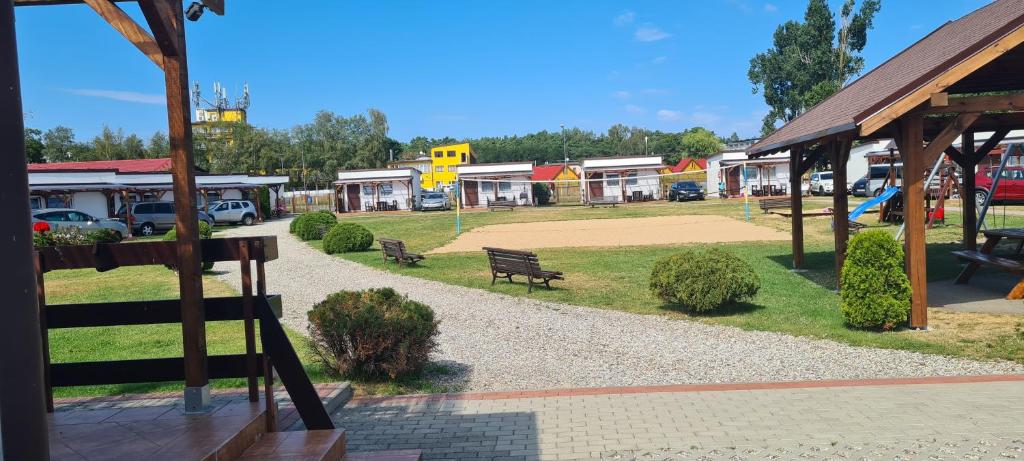 a park with a park bench and a playground at Ośrodek Wypoczynkowy Ostoja in Dźwirzyno